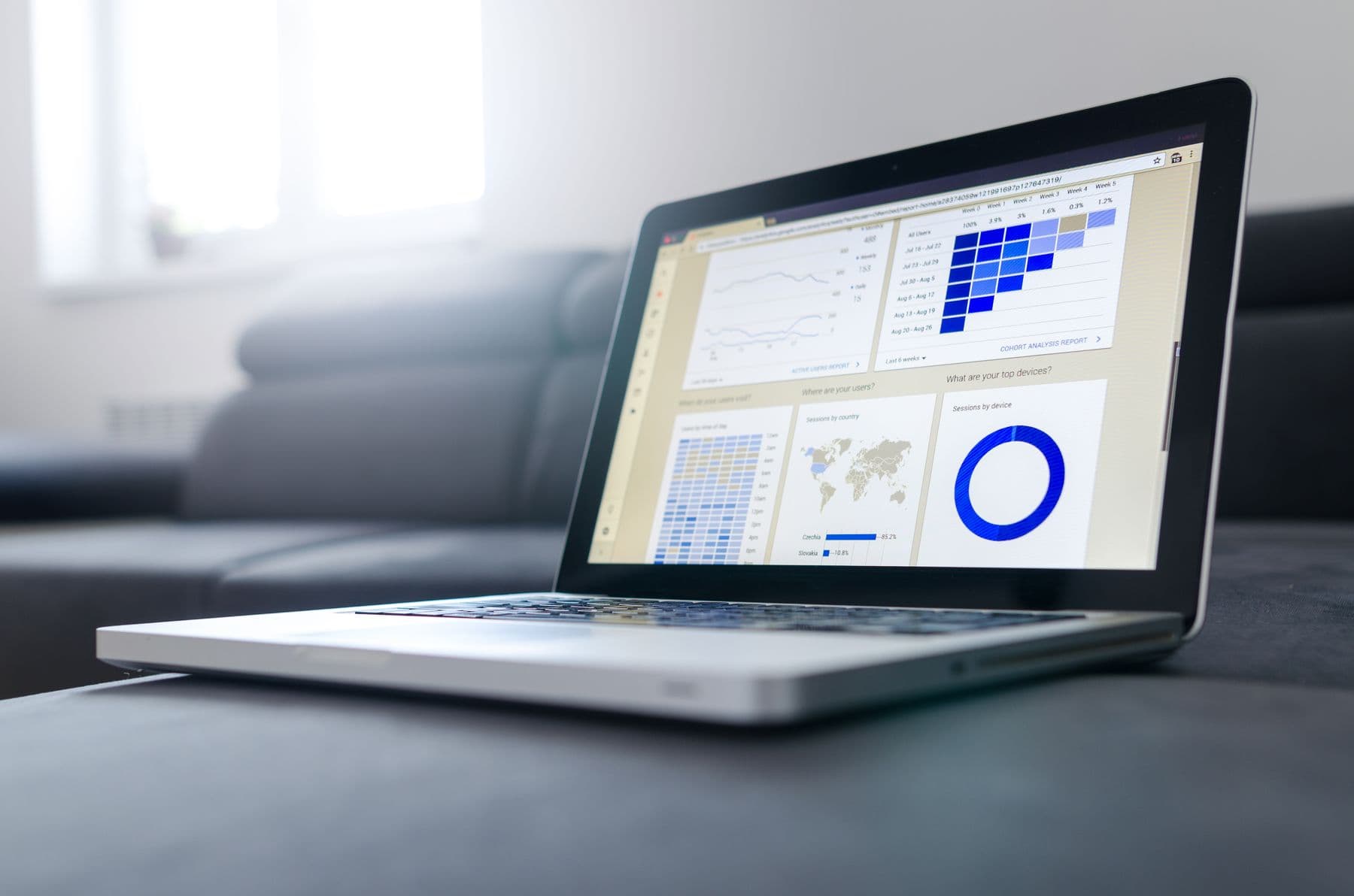 A laptop showing a clean analytics dashboard on a tidy desk in soft daylight